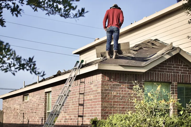 Professional roofer working on a residential roof in Potomac Yard - Potomac Greens